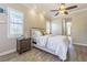 Inviting bedroom with soft natural light, neutral paint, and wood-look tile flooring creating a cozy retreat at 20142 Lace Cascade Rd, Land O Lakes, FL 34637