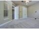 This bedroom features neutral colors, carpet, a ceiling fan, and a closet with double doors at 20142 Lace Cascade Rd, Land O Lakes, FL 34637