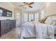 Comfortable bedroom featuring a bay window, plantation shutters, and a TV for relaxation and entertainment at 20142 Lace Cascade Rd, Land O Lakes, FL 34637