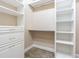 Spacious walk-in closet with custom shelving, drawers, and hanging rods for maximum storage and organization at 20142 Lace Cascade Rd, Land O Lakes, FL 34637