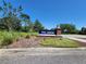 Community sign that reads 'The Arbors' with lush landscaping and a clear blue sky at 20142 Lace Cascade Rd, Land O Lakes, FL 34637
