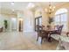 Formal dining room with chandelier, wainscoting, and natural light from large windows at 20142 Lace Cascade Rd, Land O Lakes, FL 34637