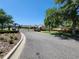 Gated entrance to the community with lush landscaping and well-maintained street at 20142 Lace Cascade Rd, Land O Lakes, FL 34637