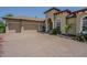 Lovely home exterior featuring a three-car garage, well-kept landscaping, and an expansive brick driveway at 20142 Lace Cascade Rd, Land O Lakes, FL 34637