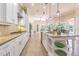 Modern kitchen featuring white cabinetry, granite countertops, a center island, and stainless steel appliances at 20142 Lace Cascade Rd, Land O Lakes, FL 34637