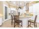 A luxurious open kitchen with a central island, pendant lighting, stainless steel appliances, and ample storage at 20142 Lace Cascade Rd, Land O Lakes, FL 34637
