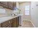 Convenient laundry room featuring modern appliances and ample counter space at 20142 Lace Cascade Rd, Land O Lakes, FL 34637