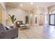 Spacious living room featuring tile flooring, plants, and neutral color palette at 20142 Lace Cascade Rd, Land O Lakes, FL 34637