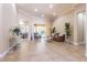 A spacious living room with tile flooring, high ceilings, and serene views of the outdoor area at 20142 Lace Cascade Rd, Land O Lakes, FL 34637