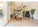 Bright and airy living area with tile flooring and seamless transition to the outdoor patio and kitchen at 20142 Lace Cascade Rd, Land O Lakes, FL 34637