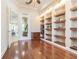 Bright office featuring custom built-in shelving, hardwood floors, and a warm and inviting atmosphere at 20142 Lace Cascade Rd, Land O Lakes, FL 34637