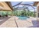 Screened-in pool with brick decking and seating area, perfect for outdoor relaxation at 20142 Lace Cascade Rd, Land O Lakes, FL 34637