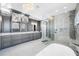 Luxurious primary bathroom boasts double vanity, elegant lighting, walk-in glass shower and freestanding tub at 2149 Bayou Grande Ne Blvd, St Petersburg, FL 33703