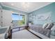 Bright bedroom with water view, hardwood floors, and sliding doors leading to a balcony at 2149 Bayou Grande Ne Blvd, St Petersburg, FL 33703