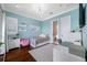 Bright bedroom with hardwood floors, a blue accent wall, and a modern lamp at 2149 Bayou Grande Ne Blvd, St Petersburg, FL 33703