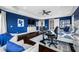 Bright blue bedroom featuring tray ceiling, dark wood floors, and a modern workstation with dual monitors at 2149 Bayou Grande Ne Blvd, St Petersburg, FL 33703