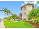 Beautiful home exterior featuring lush landscaping, a well-manicured lawn, and a private pool at 2149 Bayou Grande Ne Blvd, St Petersburg, FL 33703