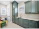 Bright laundry room with sink, custom cabinets, quartz countertops, and natural light at 2149 Bayou Grande Ne Blvd, St Petersburg, FL 33703