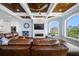 Comfortable living room with coffered ceilings, fireplace, large windows, and hardwood flooring at 2149 Bayou Grande Ne Blvd, St Petersburg, FL 33703
