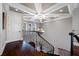 Elegant staircase with hardwood floors, wrought iron railings, and coffered ceilings at 2149 Bayou Grande Ne Blvd, St Petersburg, FL 33703