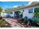 Backyard patio with garden beds and outdoor furniture, perfect for relaxing or entertaining guests at 2200 Marshall Dr, Dunedin, FL 34698