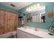 Bathroom features a vanity with a white countertop, large mirror, and decorated walls with dandelion art at 2200 Marshall Dr, Dunedin, FL 34698