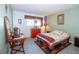 Bedroom features light green walls, neutral tile flooring, a window, and a cozy bed at 2200 Marshall Dr, Dunedin, FL 34698