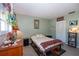 Bedroom featuring light green walls, neutral tile flooring, closet and a comfortable looking bed at 2200 Marshall Dr, Dunedin, FL 34698