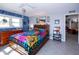 Bright bedroom featuring a spacious bed, tiled floors, and a calming color scheme at 2200 Marshall Dr, Dunedin, FL 34698