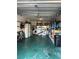 The spacious garage is well-organized and includes laundry machines, storage racks, and bicycles at 2200 Marshall Dr, Dunedin, FL 34698