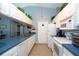 Efficient kitchen with white appliances, blue counters, ample cabinet space and modern features at 2200 Marshall Dr, Dunedin, FL 34698