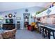 Cozy living room features tile floors, light blue walls, and a pass through kitchen area with bar stool seating at 2200 Marshall Dr, Dunedin, FL 34698