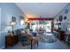 Bright living room boasts stylish decor, tile flooring, and sliding glass doors to the outdoor space at 2200 Marshall Dr, Dunedin, FL 34698