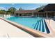 Community pool with sun deck and lounge chairs, perfect for relaxation and recreation at 2200 Marshall Dr, Dunedin, FL 34698