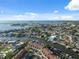 An aerial view of waterfront community with canal access to the open bay and blue skies at 2387 Hanover Dr # 2387, Dunedin, FL 34698