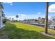 Well-manicured backyard with lush lawn and picturesque views of the canal and boat docks at 2387 Hanover Dr # 2387, Dunedin, FL 34698