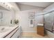 Bathroom featuring a vanity, countertop, framed mirror, shower over bath, and tiled flooring at 2387 Hanover Dr # 2387, Dunedin, FL 34698