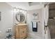 Charming bathroom with vanity, framed mirror, decorative painting, and tiled walk-in shower at 2387 Hanover Dr # 2387, Dunedin, FL 34698