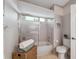 This bathroom has neutral wall color with a shower and tub combo at 2387 Hanover Dr # 2387, Dunedin, FL 34698