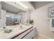 Bathroom features large mirror, vanity, shower, and tiled floors and adds a bright and clean atmosphere at 2387 Hanover Dr # 2387, Dunedin, FL 34698