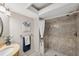 A bright bathroom featuring a tiled shower, a marble countertop, and updated fixtures at 2387 Hanover Dr # 2387, Dunedin, FL 34698