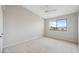 Bright bedroom featuring plush carpeting, ceiling fan and a large window providing ample natural light at 2387 Hanover Dr # 2387, Dunedin, FL 34698
