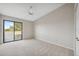 Bright bedroom with carpet, ceiling fan, access to a balcony and a sliding door that lets in plenty of natural light at 2387 Hanover Dr # 2387, Dunedin, FL 34698