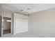 A bright bedroom features a ceiling fan, carpet flooring, and a closet with paneled doors for ample storage at 2387 Hanover Dr # 2387, Dunedin, FL 34698