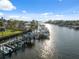 Exterior shot highlighting a private boat dock on a sunny day with boats and sparkling water at 2387 Hanover Dr # 2387, Dunedin, FL 34698
