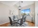Dining area features a modern light fixture, seating for six, and a large picture window at 2387 Hanover Dr # 2387, Dunedin, FL 34698