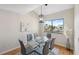 Dining area with vaulted ceiling, modern table set, and bright window with water view at 2387 Hanover Dr # 2387, Dunedin, FL 34698