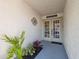 Welcoming entryway with a decorative door, tasteful decor, and lush plants, creating a warm first impression at 2387 Hanover Dr # 2387, Dunedin, FL 34698