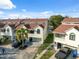 Exterior of the waterfront condo with garages, landscaping, and a view of the canal at 2387 Hanover Dr # 2387, Dunedin, FL 34698