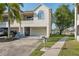 Charming two-story home featuring an attached garage, manicured lawn, and mature landscaping in the front yard at 2387 Hanover Dr # 2387, Dunedin, FL 34698